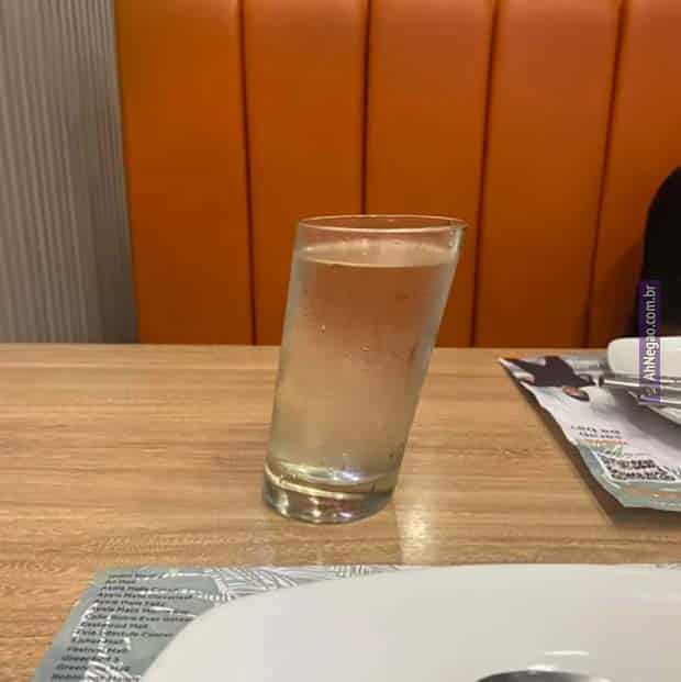 a plate with a glass of beer on a table